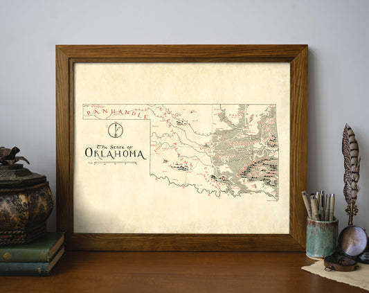 The Oklahoma NEW Updated Version framed art print by Lord of Maps features a vintage-style, hand-drawn map labeled "The State of Oklahoma," displayed on a wooden desk with books, a decorative jar, an ink bottle, and a quill pen.